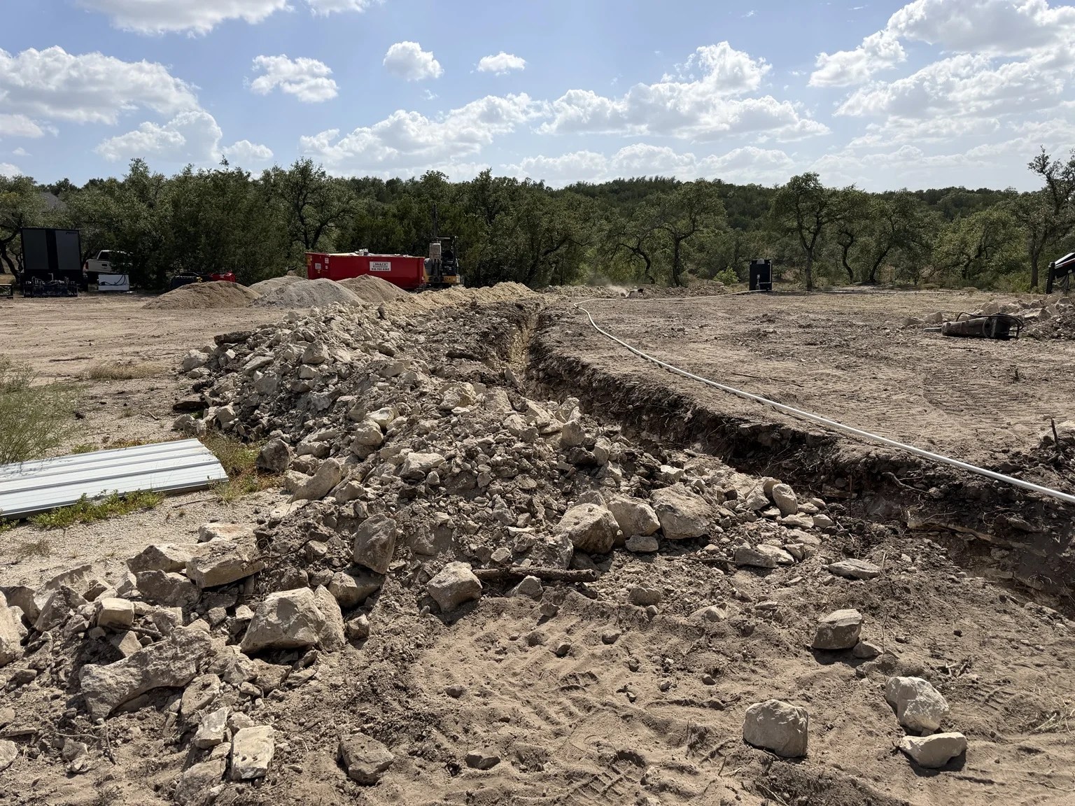 Excavation trench through rocky ground on a Terrain Land Services job